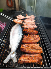 Pork and Bangus Fish on the Grill in a Garage: Mouthwatering BBQ with Fragrant Smoke