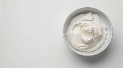 Glass bowl with creamy yogurt on white background