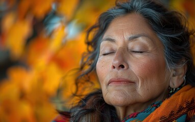 An adult Hispanic individual engages in mindfulness meditation, surrounded by vibrant autumn foliage, enjoying a peaceful moment of tranquility