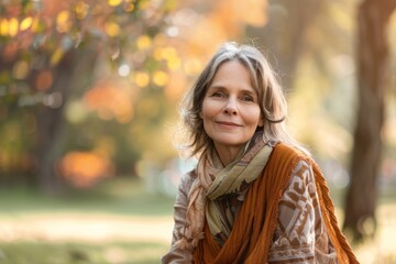 portrait of lovely middle aged woman sitting at the park