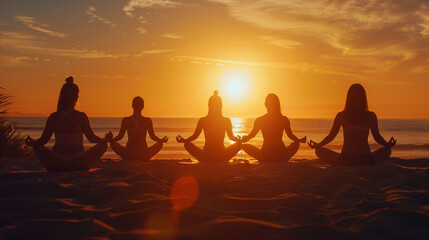 Obraz premium Five Individuals Practicing Meditation on the Beach During a Stunning Sunset