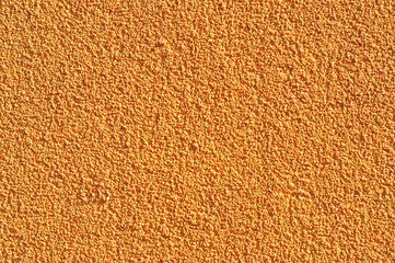 Dark yellow or ochre wall, plastered in stucco (plastered) wall. Textured architectural background