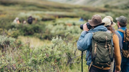 Fototapeta premium A group of nature lovers spotting rare wildlife while hiking