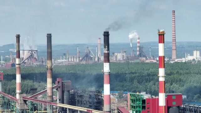 Aerial drone view Coking Plant factory. Coke plant. Heavy industry in Europe, Poland, Dabrowa Gornicza. Air pollution from chimneys. Close up shot of the chimneys from the steelworks coking plant.