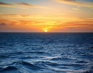 Fototapeta premium Stunning sea view with horizon under a bright sunset sky in evening time