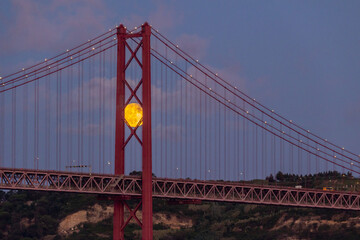 Full Moon and 25 April Bridge. Lisbon, Portugal.