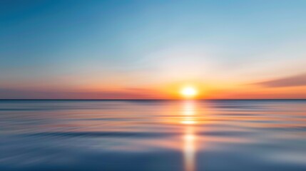 Obraz premium Tranquil Blurred Sunset Over Ocean - Serene and Calming Seascape View at Dusk