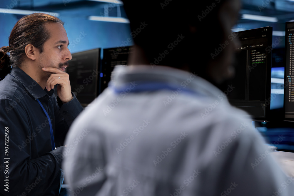 Poster it engineers in data center facility using diagnostic tools and system monitoring software to identi