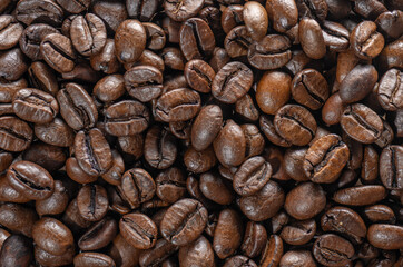 Heap of roasted coffee beans top view