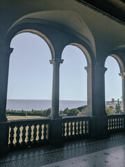 View through the arches from the balcony of the Breakers Mansion overlooking the Atlantic Ocean in...