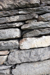 Gray stone blocks with soil and plants.

