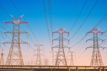 Overhead line pylons, high voltage pylons. Power transmission towers and lines at sunset. A shot of high voltage electric transmission tower, also known as electricity pylon...