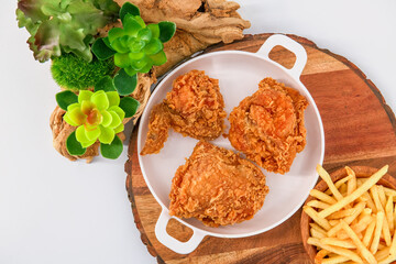 crispy Fried chicken  with french fries on isolated background, chicken broasted with potato chips, Broasted chicken is battered and cooked in oil as well, crispy fried chicken.