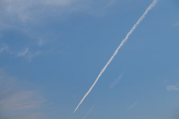 The trail left by a passenger plane in the sky.