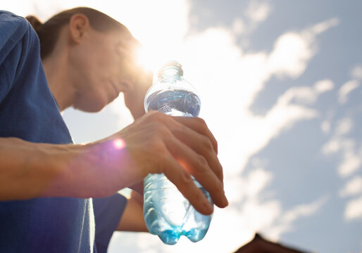 Woman drinking water in extreme heat