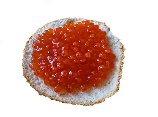 Red caviar on a bun isolated on white background. Bun with red caviar on isolated on white.