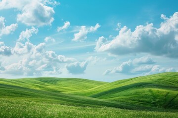 Obraz premium Tranquil panoramic landscape of green hills on a sunny day under a clear blue sky