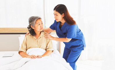 Female doctor nurse take care elderly female patient who is being treated for discomfort due congenital disease gently supporting her shoulder to help her sleep : Elderly health insurance.