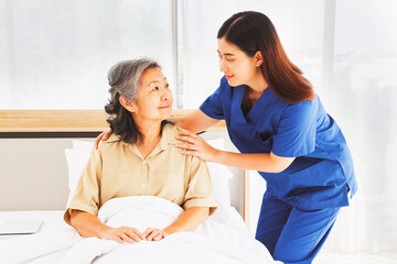 Obraz premium Female doctor nurse take care elderly female patient who is being treated for discomfort due congenital disease gently supporting her shoulder to help her sleep : Elderly health insurance.