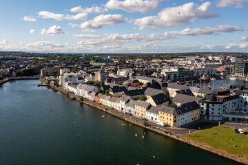 Aerial photograph showcasing Galway city’s Long Walk bathed in sunlight on a clear day