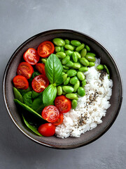 A bowl of rice topped with edamame, chopped tomatoes, and fresh basil, highlighting a wholesome and colorful vegan meal.