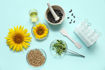 Professional laboratory tools with sunflowers, seeds and sprouts on blue background
