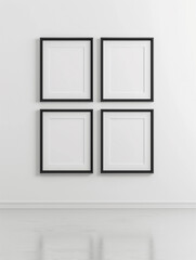 Four blank black frames arranged in a grid pattern on a white wall for a minimalist decor
