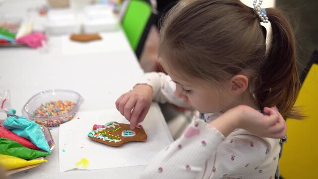A Curious Child is Enthusiastically Decorating a G