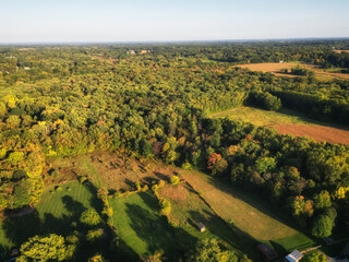 Aerial over a wooded area in Berrien Springs, in Berrien County, within the Oronoko Charter Township, Michigan, United States. A rural community with farms and lakeside and riverside properties.
