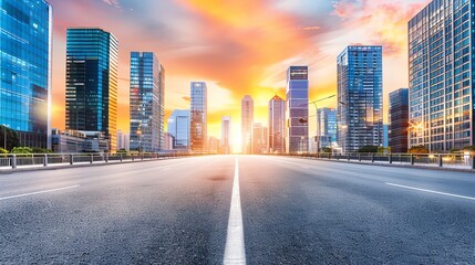 Fototapeta premium Empty urban road with skyscrapers at sunset, cityscape showcasing modern architecture and vibrant colors.