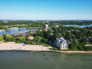 Aerial over Lakeside Park Beach in the Port Dalhousie area of St. Catharines, Ontario, Canada, on the south shore of Lake Ontario, with Martindale Pond. Shot on a summer afternoon in July, 2024.