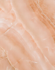 Fototapeta premium Closeup of a peach colored marble texture with natural veins and patterns