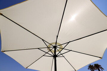 A canopy for protection from the hot sun in a city park.