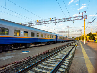 Railway tracks. Train on the tracks. Station, platform. Train cars. Train ride.