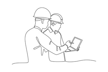 construction worker looking at work tablet. Labor Day