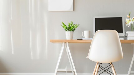 A clean and minimalist home office setup featuring a computer, potted plant, and white chair, creating a serene workspace..