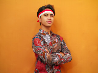 Handsome Indonesian man in Batik shirt celebrating Indonesian Independence Day on August 17...