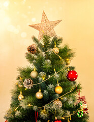 Merry Christmas and Happy New Year concept. Christmas tree decorated with Star on top, lighting, pine cones, santa claus, red and gold ball, festive party ornament on white background, vertical style.