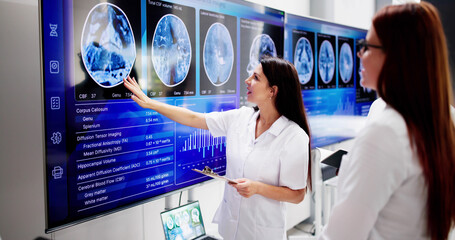 Doctors In Clinic Looking At Brain MRI Scan