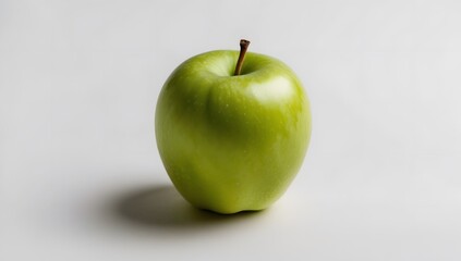 A single green apple with a leaf on a white background, the apple is smooth and shiny, and the leaf is green and vibrant