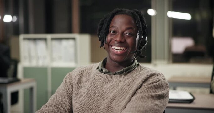 Face, smile and black man in telemarketing office for customer service, consulting and business crm. Male advisor or agent, inbound call center and headphone for listening, communication and support.