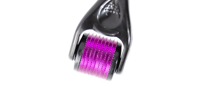 Derma Roller for Face Micro Needling close up
Beauty treatment, mesotherapy or medical collagen production stimulation and micro needling therapy concept pink and black derma roller isolated