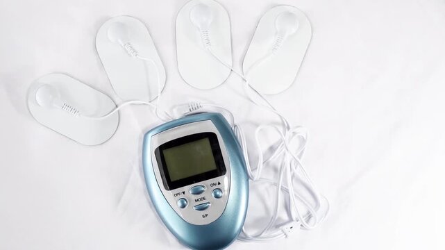 Electric massage procedure in physiotherapy, Electrical frequency therapy, alternative medicine Electrotherapy, electrical stimulation using surface electrode pads, Transcutaneous nerve device closeup