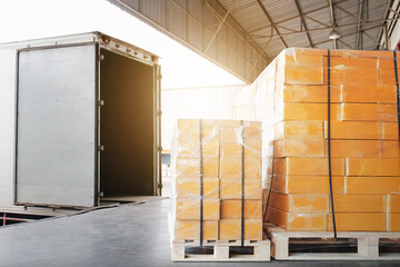 Bulk Pallets of Packaging Boxes Being Loaded onto a Container Trucks. Distribution Warehouse Container Transport, Supply chain, Parcel Delivery. Freight truck, Logistics, Transportation.