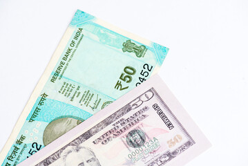 US dollar and Indian currency exchange rate. Close-up of US dollar and Indian paper currency.
