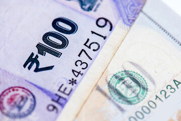 US dollar and Indian currency exchange rate. Close-up of US dollar and Indian currency.