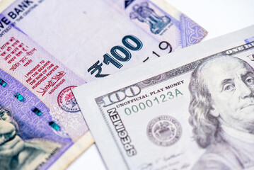 US dollar and Indian currency exchange rate. Close-up of US dollar and Indian currency.