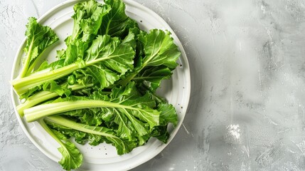 Turnip greens on white plate on ceramic surface