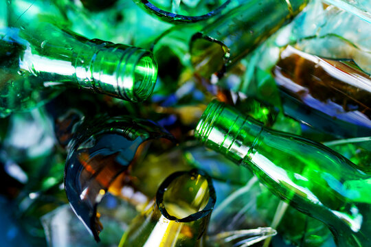 Broken glass bottles, background, texture. Broken glass bottles for recycling. Background of broken glass for recycle. Recyclable garbage, recovery of waste. Broken glass Waste Recycled.