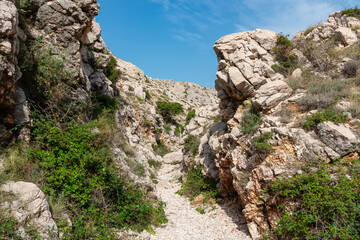 Narrow, rocky gorge Vrzenica (Žig Vrženica) cuts through rugged landscape in Baska, Krk Otok,...